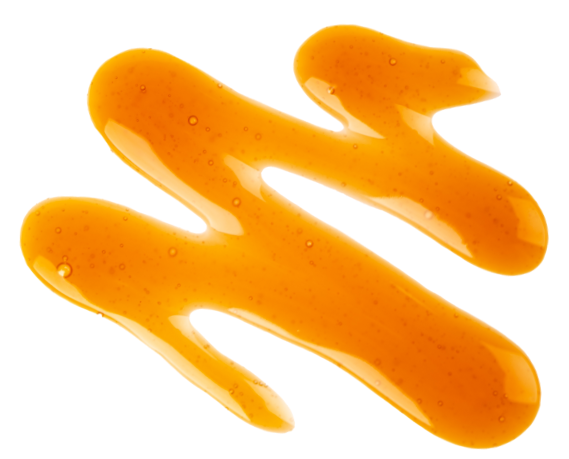 Close-up of golden maple syrup drizzled with smooth, glossy texture reflecting light on a white background