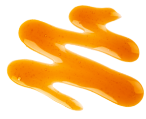 Drizzle of golden maple syrup with smooth texture and glossy sheen on a white background