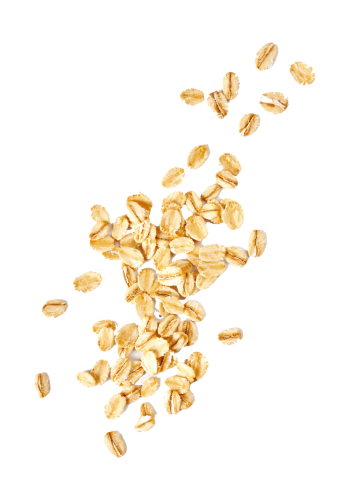 Scattered natural oat flakes representing wholesome ingredients for maple-sweetened organic kids snacks.